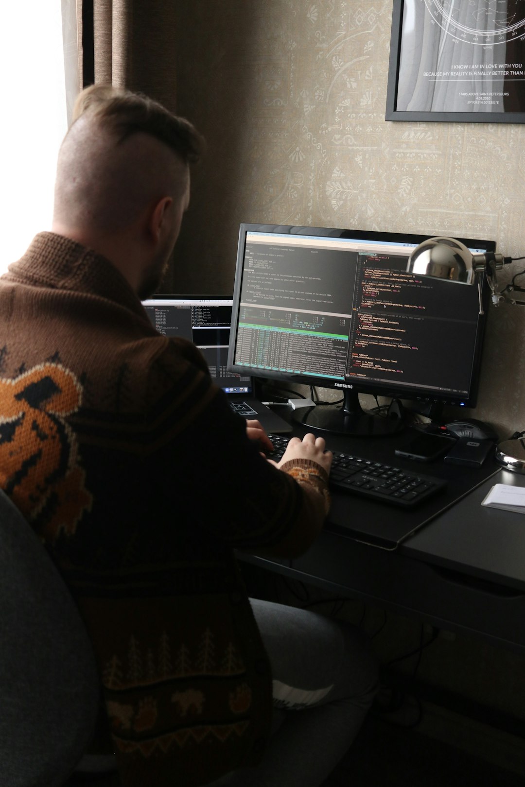 a-man-sitting-in-front-of-a-computer-on-a-desk-42qdootuc4a